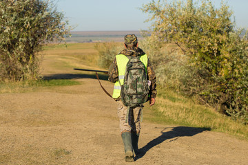 Hunters with a german drathaar and spaniel, pigeon hunting with dogs in reflective vests