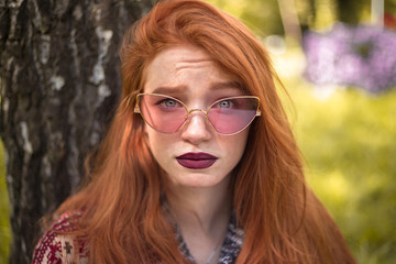 Closeup portrait of redhead confused emotional woman