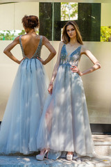 Two fashion models in long gown