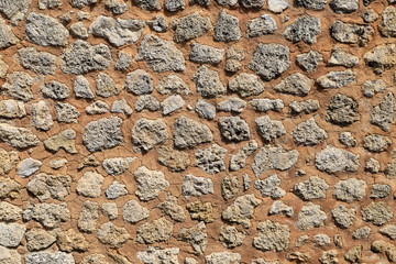 Old sandstone wall as background. Beautifully textured and weathered.