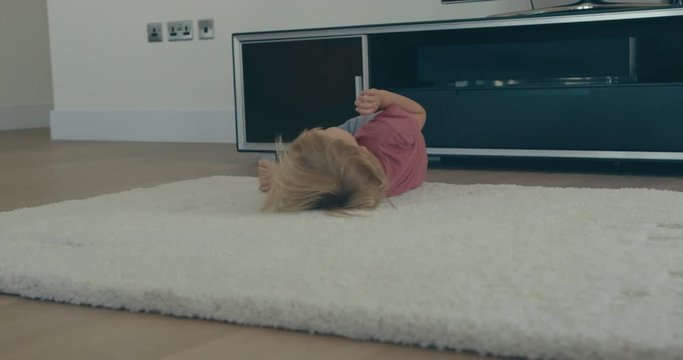 Little toddler doing roly polies at home
