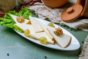 Suluguni cheese sliced on a plate
