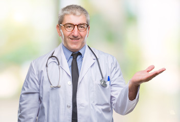 Handsome senior doctor man over isolated background smiling cheerful presenting and pointing with palm of hand looking at the camera.