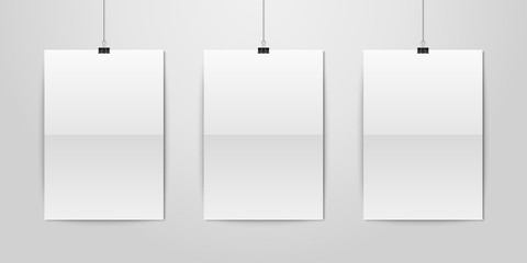 Three Vector Realistic White Blank Vertical A4 Folded Paper Poster Hanging on a Rope with Binder Clip Set on White Wall mock-up. Empty Poster Design Template for Graphics, Mockup