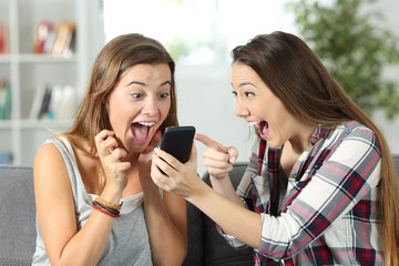 Excited friends watching online amazing content