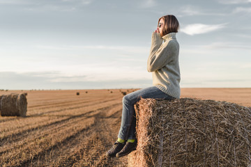 Naklejka na ściany i meble Young woman outdoors in a corn field