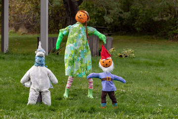 boy and girl pumpkin scarecrow in autumn park