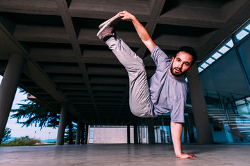 Sportive man make tricks while exercise parkour