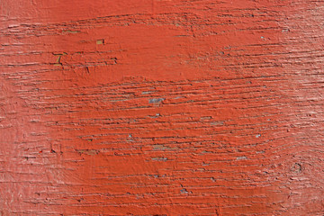 Wooden background. Old red paint on the wood texture