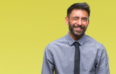 Adult hispanic business man over isolated background winking looking at the camera with sexy...