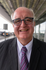 Overweight senior businessman lounging around the airport of Ban