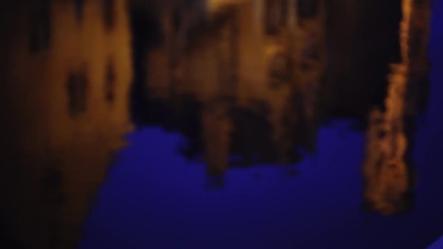 Background plate of water in the canals of Bruges reflecting rooftops at night