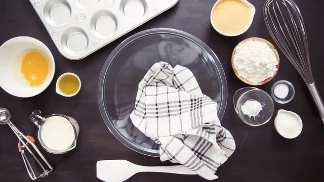 Time lapse. Step by step. Buttering metal cupcake pan to bake cornbread muffins.