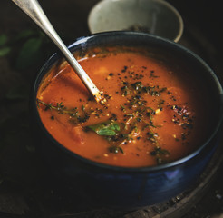 Homemade tomato soup in a black bowl