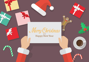 Santa Claus hands holding a Merry Christmas and Happy new year sign with Christmas decoration