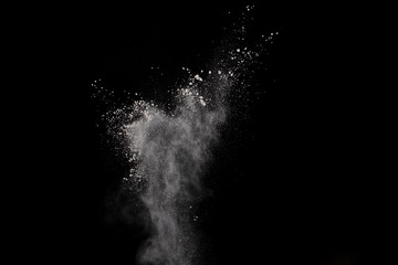 White powder isolated on black background.