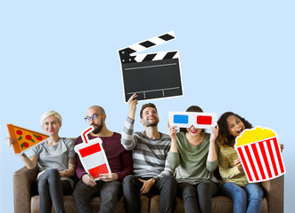Group of diverse friends holding movie emoticons