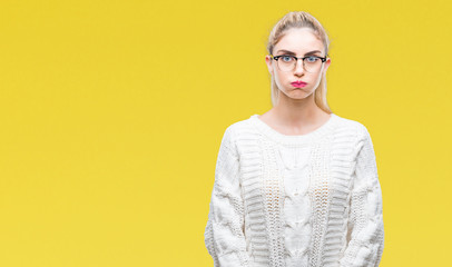 Young beautiful blonde woman wearing glasses over isolated background puffing cheeks with funny face. Mouth inflated with air, crazy expression.