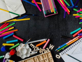 Back to school concept with Drawing book, crayons, coloured pencils, Poster color and School...