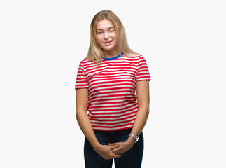 Young caucasian woman over isolated background winking looking at the camera with sexy expression,...