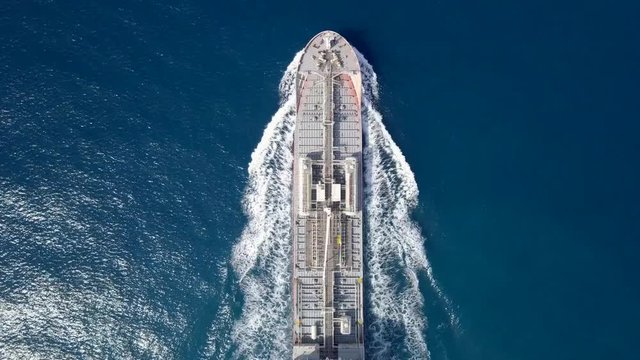 Large crude oil tanker roaring across The Mediterranean sea - Aerial footage following the ship