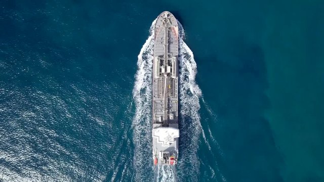 Large crude oil tanker roaring across The Mediterranean sea - Aerial footage following the ship