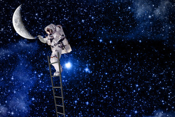 the spaceman on ladder traveling on moon in outer space.elements of this image furnished by NASA