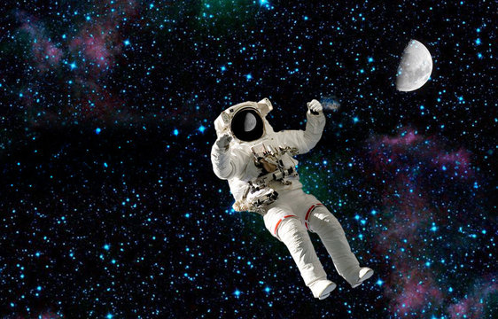 the spaceman flying in traveling on moon.elements of this image furnished by NASA