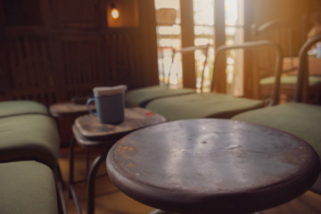 Empty black metal table top and blurred bokeh cafe and restaurant interior background with vintage filter - can used for display or montage your products.