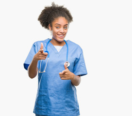Young afro american doctor woman over isolated background pointing fingers to camera with happy and...