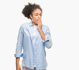 Young afro american woman over isolated background bored yawning tired covering mouth with hand. Restless and sleepiness.