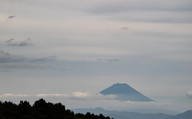 Fototapeta premium The tip of Mt. Fuji in a cloudy sky