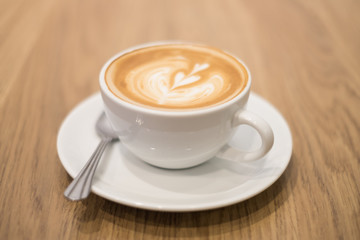 Fototapeta na wymiar Latte coffee on the wood table.