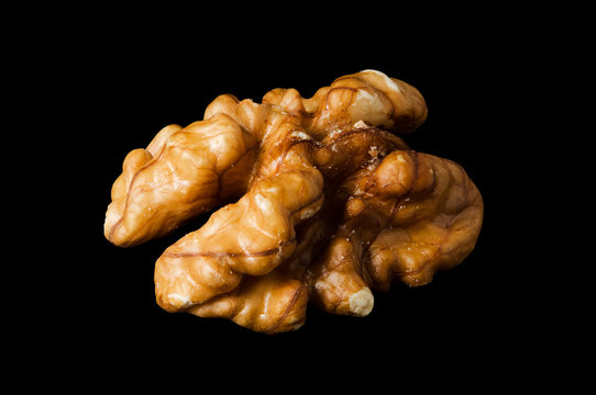 Walnut kernel, nut isolated on black background