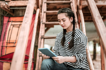 Online chat. Beautiful girl bowing head while reading message