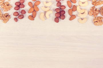 Different nuts and almonds as source vitamins and minerals, copy space for text on white board