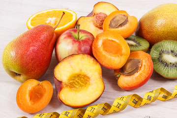Tape measure and healthy nutritious food as source natural minerals, vitamins and fiber