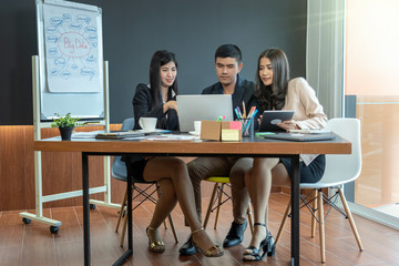 Group Of Asian and Multiethnic Business people with formal suit working and brainstorming together with technology computer in the modern Office, people business group and entrepreneurship concept.