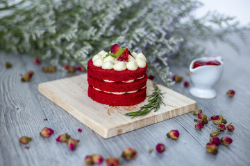 sweet strawberry cake  on the wood near the nice flowers