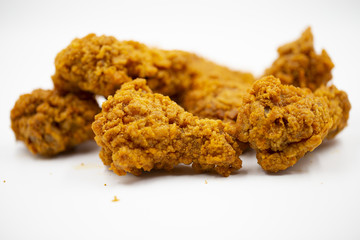 Delicious crispy fried chicken on a white background.