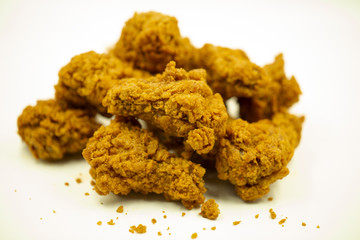 Delicious crispy fried chicken on a white background.