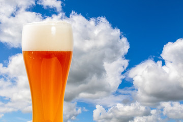 glass of beer on a background of blue sky