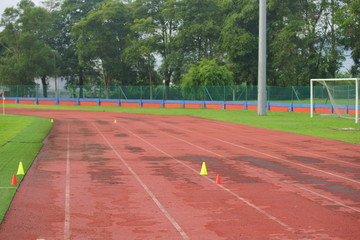 Artificial track and field with green grass combined with artificial grass