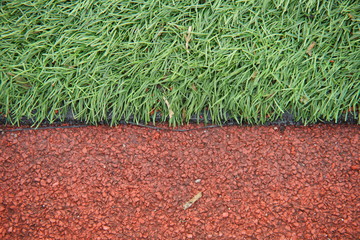 Artificial track and field with green grass combined with artificial grass