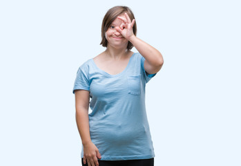Young adult woman with down syndrome over isolated background doing ok gesture with hand smiling, eye looking through fingers with happy face.