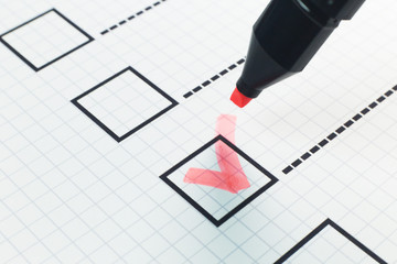  red pen check point in black box on paper.