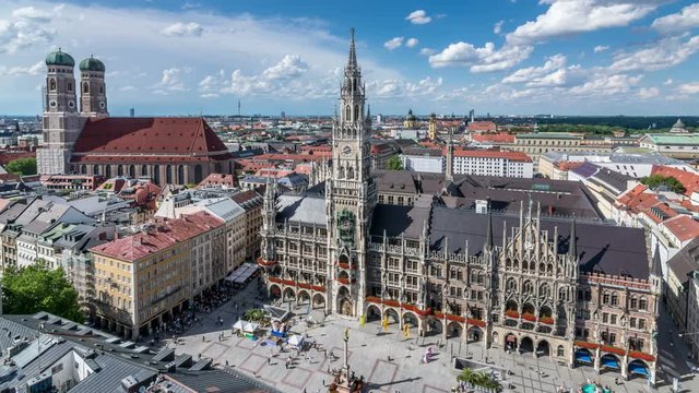 Panoramic view of Marienplatz, the main square of Munich. City skyline. White clouds move across blue sky.