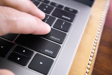 Close up of hand type on laptop keyboard