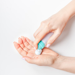 Woman moisturizing her hands with foam lotion