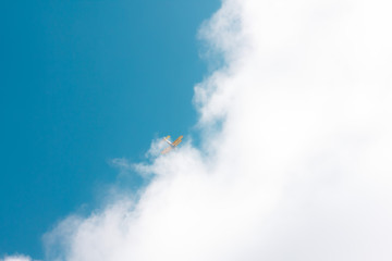 Fototapeta na wymiar sun and cumulus white clouds against a beautiful blue sky, fly plane